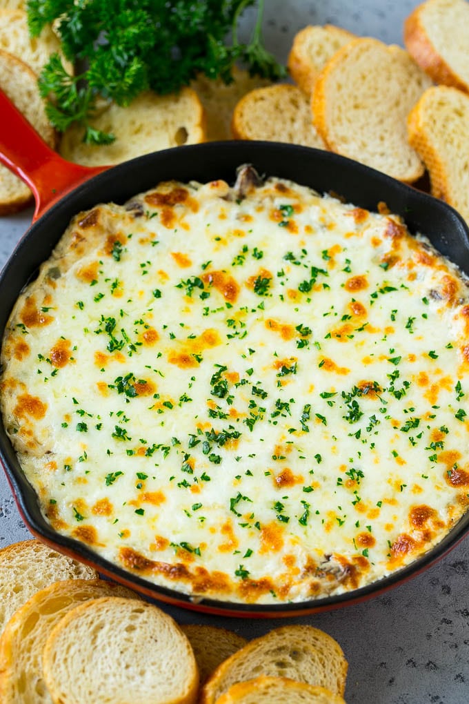Philly Cheesesteak Dip Recipe | Cheesy Dip | Baked Cheese Dip #steak #dip #appetizer #cheese #ezlod A skillet of baked Philly cheesesteak dip with melted cheese and parsley on top.