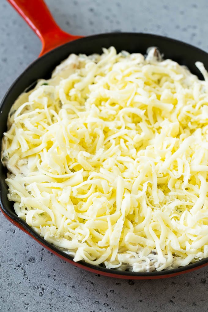 Philly Cheesesteak Dip Recipe | Cheesy Dip | Baked Cheese Dip #steak #dip #appetizer #cheese #ezlod Philly cheesesteak dip with shredded cheese on top, waiting to go into the oven.