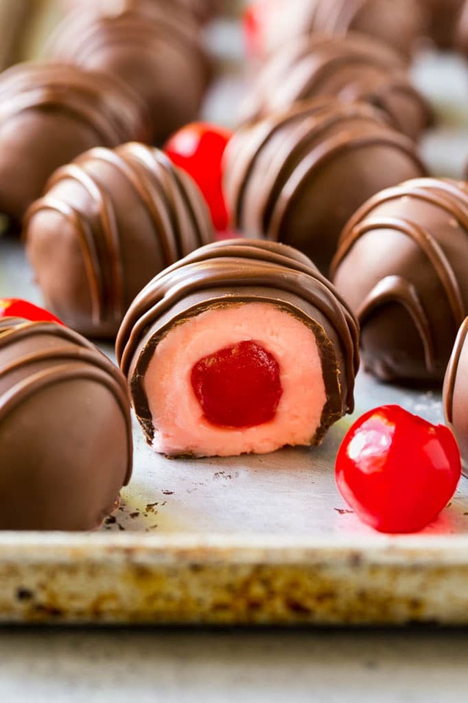Chocolate Covered Cherries Recipe | Cherry Cordials | Cherry Candy #chocolate #candy #dessert #cherry #sweets #ezlod Chocolate covered cherries dipped in dark chocolate with a decorative drizzle.