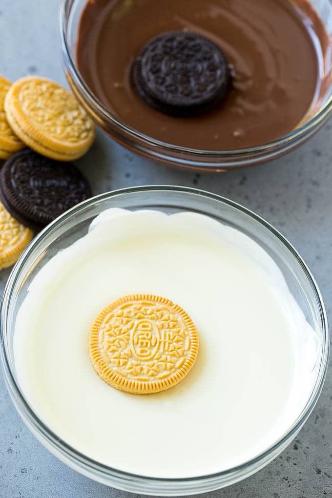 Chocolate Covered Oreos Recipe | Oreo Cookies | Chocolate Dipped Oreos #oreo #cookies #chocolate #sprinkles #dessert #ezlod Cookies being dipped into dark and white chocolate.