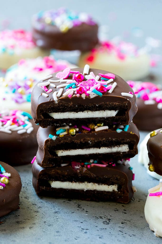 Chocolate Covered Oreos Recipe | Oreo Cookies | Chocolate Dipped Oreos #oreo #cookies #chocolate #sprinkles #dessert #ezlod Three chocolate covered Oreos stacked on top of each other.