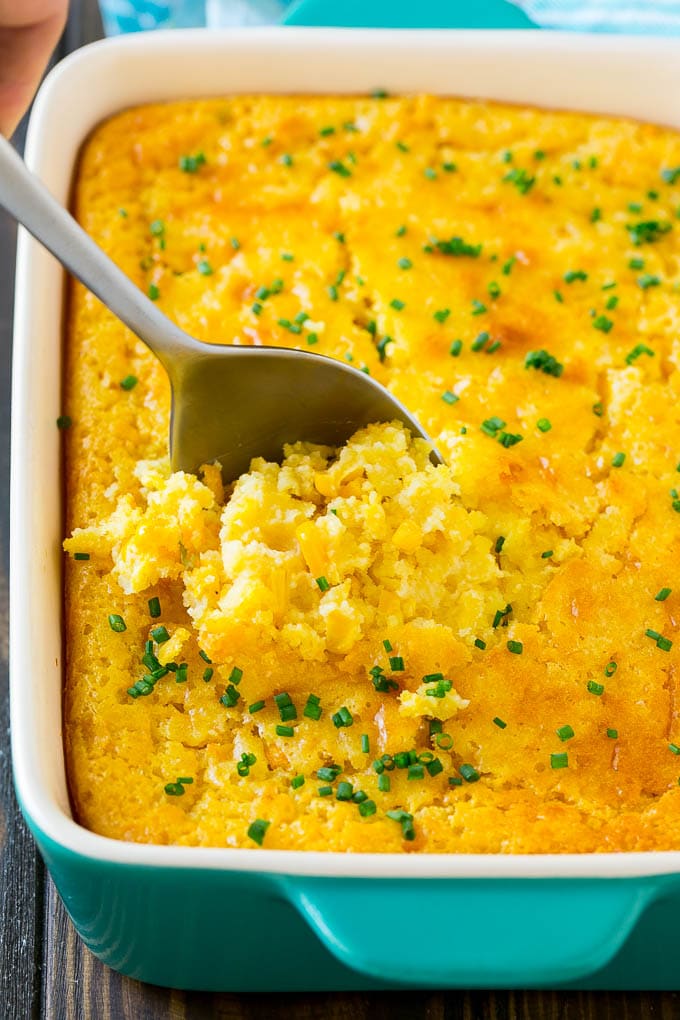 Corn Pudding Recipe | Corn Casserole | Corn Side Dish #corn #pudding #casserole #sidedish #thanksgiving #dinner #ezlod A pan of corn pudding with a serving spoon in it.