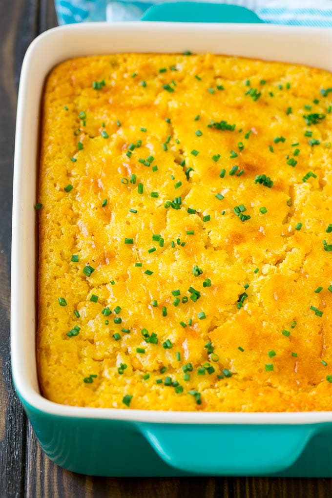 Corn Pudding Recipe | Corn Casserole | Corn Side Dish #corn #pudding #casserole #sidedish #thanksgiving #dinner #ezlod A casserole dish of corn pudding topped with chives.