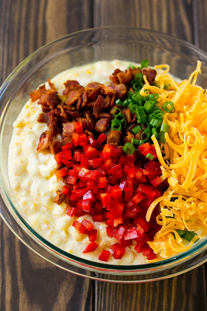 Loaded Corn Casserole Recipe | Easy Corn Casserole | Bacon Corn Casserole | Corn Pudding #corn #casserole #bacon #cheese #sidedish #thanksgiving #dinner #ezlod A bowl of batter with red pepper, green onions, cheddar cheese and bacon.