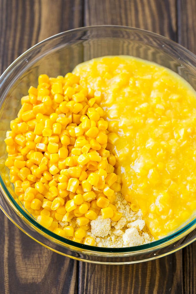 Loaded Corn Casserole Recipe | Easy Corn Casserole | Bacon Corn Casserole | Corn Pudding #corn #casserole #bacon #cheese #sidedish #thanksgiving #dinner #ezlod Cornbread mix, corn and creamed corn in a mixing bowl.