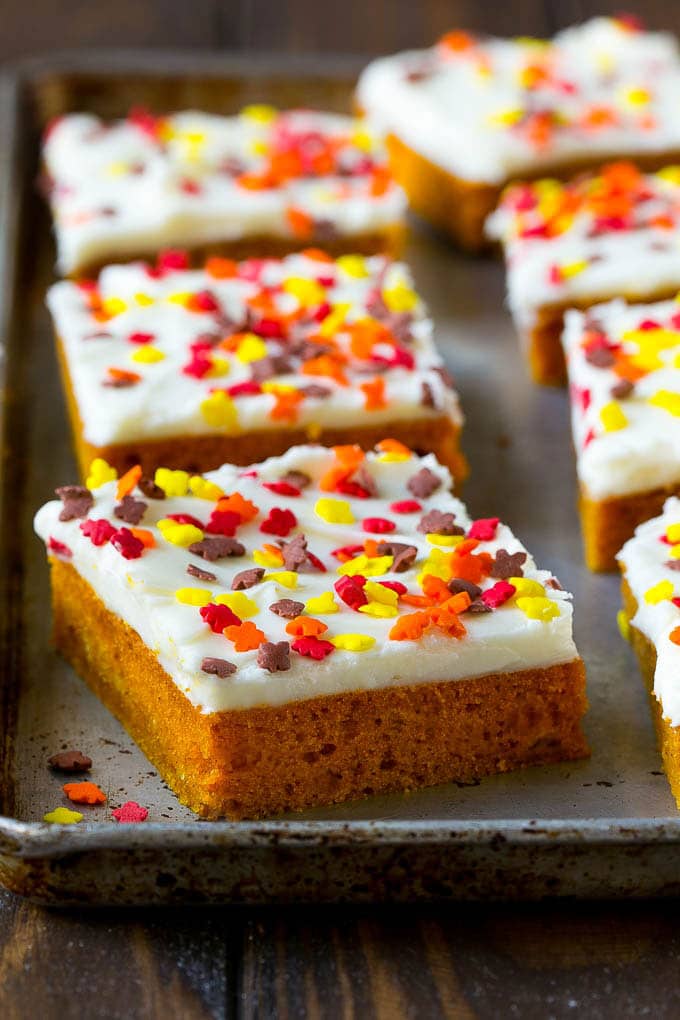 Pumpkin Bars Recipe | Pumpkin Cake | Pumpkin Dessert #pumpkin #fall #dessert #ezlod #thanksgiving A baking sheet of frosted pumpkin bars.
