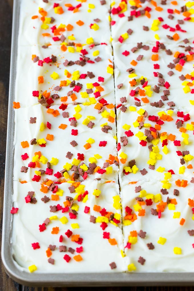 Pumpkin Bars Recipe | Pumpkin Cake | Pumpkin Dessert #pumpkin #fall #dessert #ezlod #thanksgiving Cream cheese frosting and sprinkles spread over cake.
