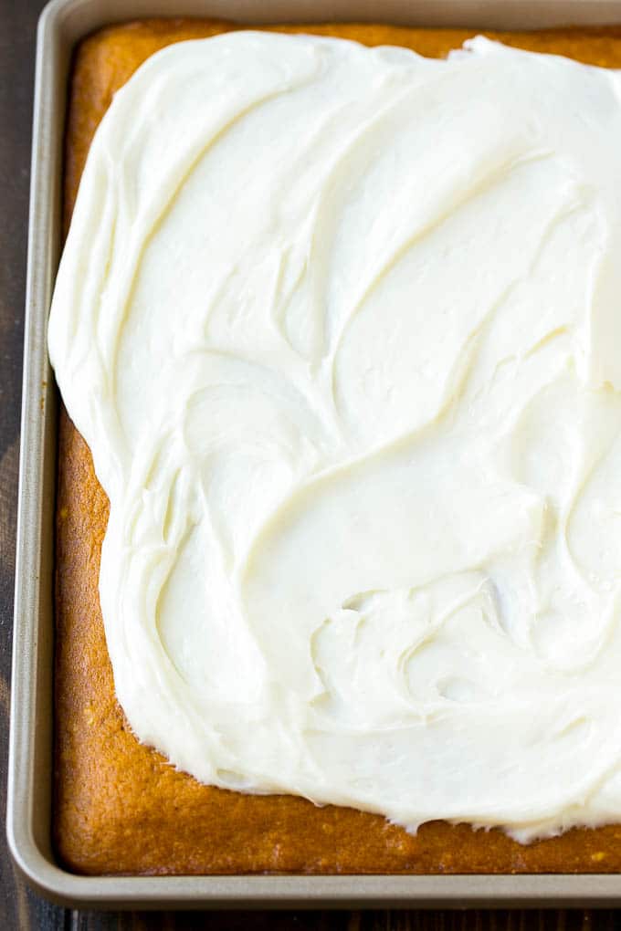 Pumpkin Bars Recipe | Pumpkin Cake | Pumpkin Dessert #pumpkin #fall #dessert #ezlod #thanksgiving Cream cheese frosting spread over cake.