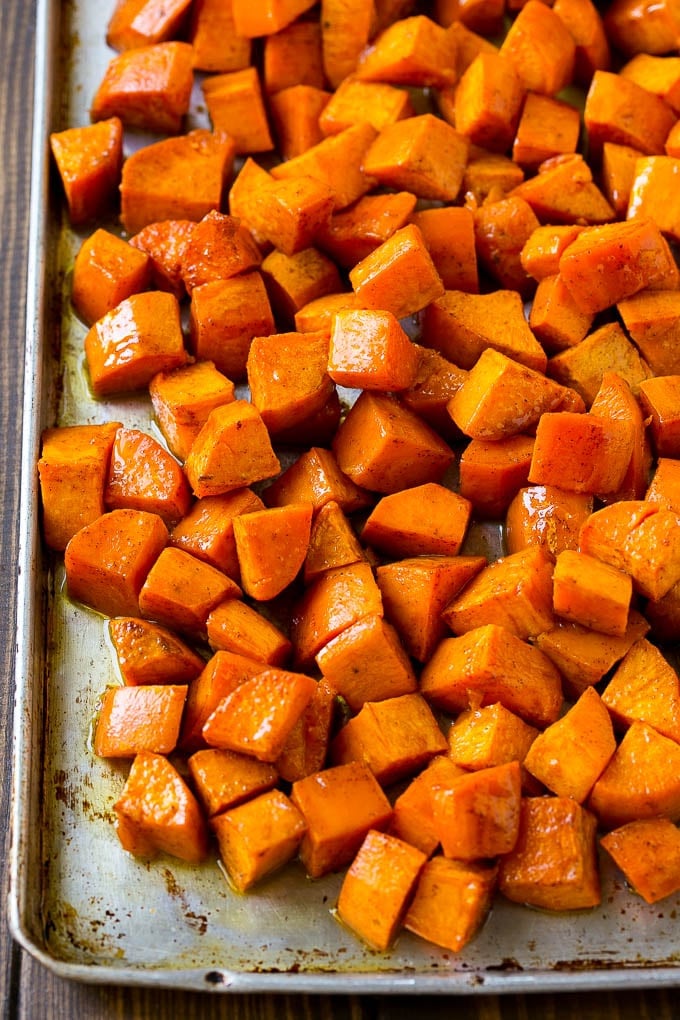 Maple Roasted Sweet Potatoes Recipe | Easy Sweet Potatoes | Baked Sweet Potatoes | Sweet Potato Side Dish #sweetpotatoes #cinnamon #maple #butter #fall #sidedish #dinner #ezlod A sheet pan of roasted sweet potatoes.