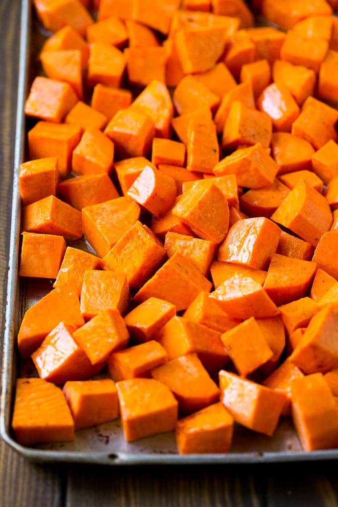 Maple Roasted Sweet Potatoes Recipe | Easy Sweet Potatoes | Baked Sweet Potatoes | Sweet Potato Side Dish #sweetpotatoes #cinnamon #maple #butter #fall #sidedish #dinner #ezlod Raw diced sweet potatoes on a sheet pan, ready to go into the oven.