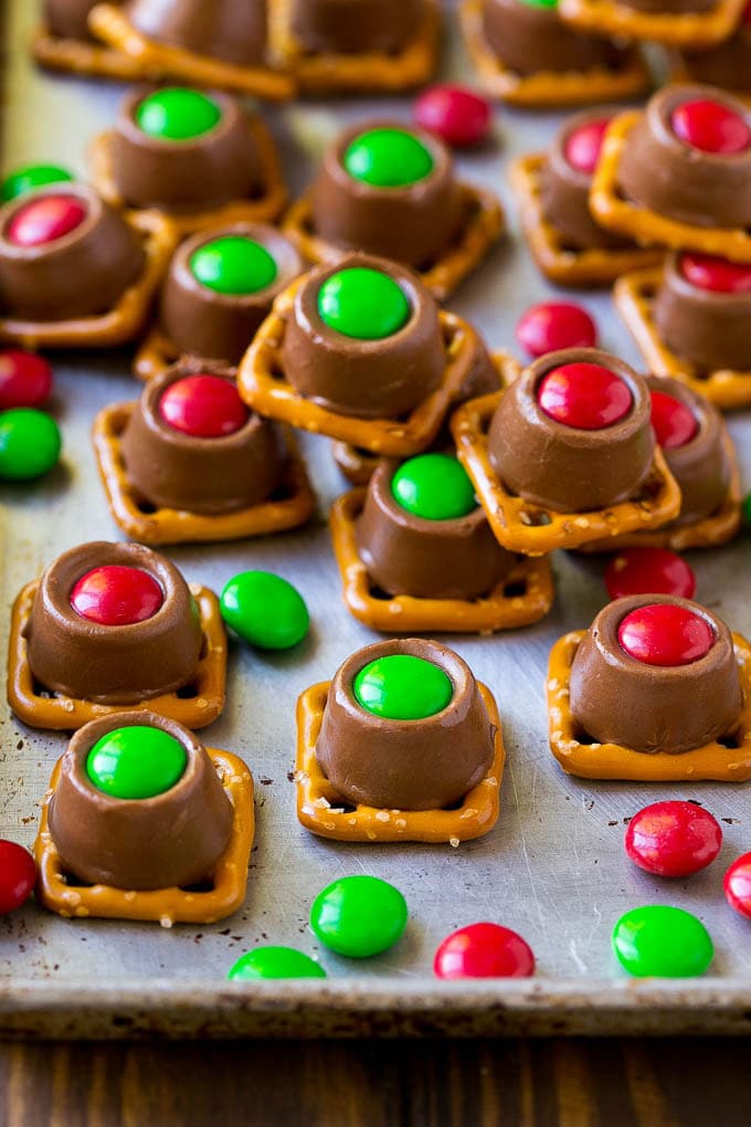 Rolo Pretzels Recipe | Chocolate Pretzels | Caramel Pretzels | Holiday Candy #christmas #baking #dessert #candy #chocolate #caramel #pretzels #ezlod Rolo pretzels on a baking sheet topped with red and green M&M's.