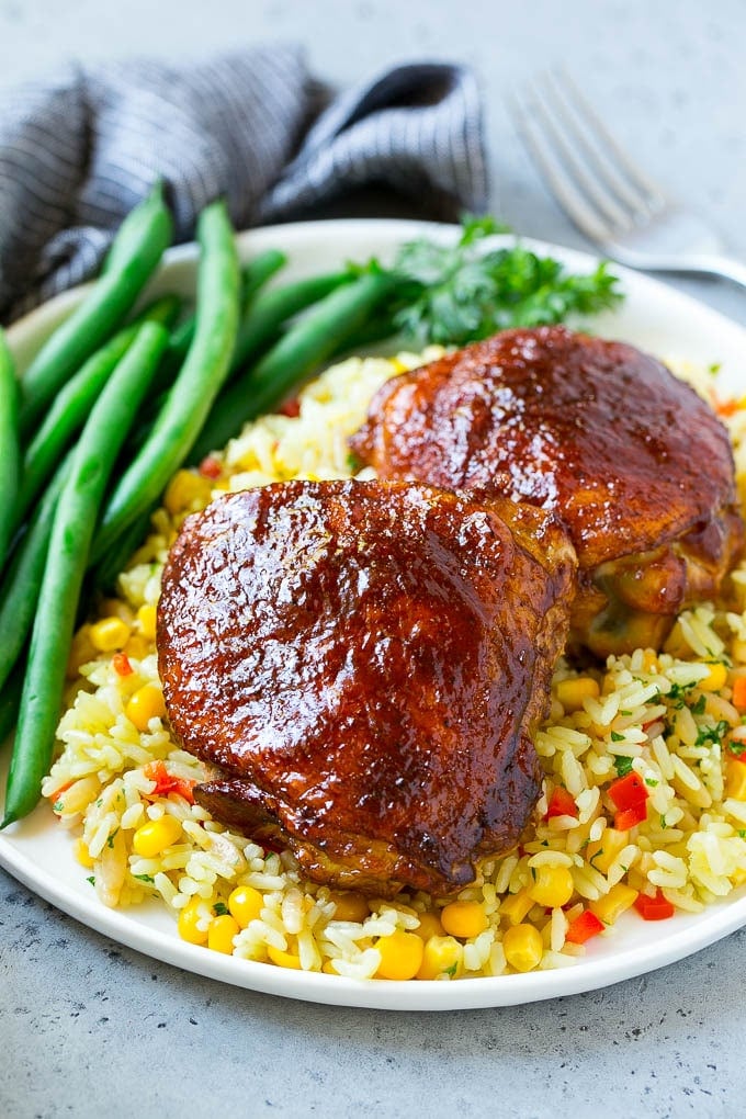 Smoked Chicken Thighs Recipe | Barbecue Chicken Thighs | Easy Chicken Thighs #chicken #barbecue #smoker #dinner #ezlod A serving of smoked chicken thighs served with rice and green beans.