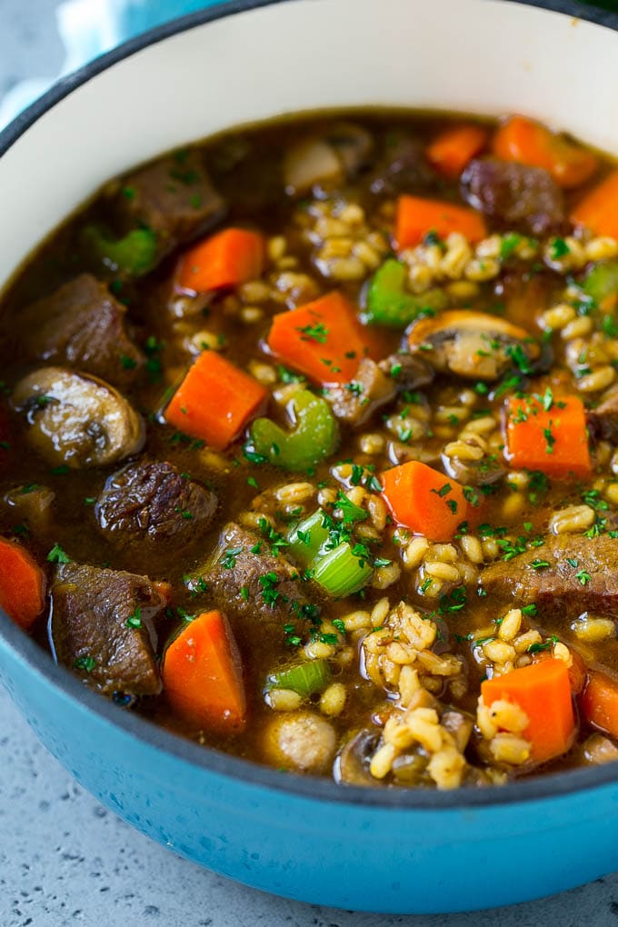 Beef Barley Soup Recipe | Beef Soup | Barley Soup #soup #beef #dinner #vegetables #ezlod #comfortfood A pot of beef barley soup with mushrooms, carrots and celery.