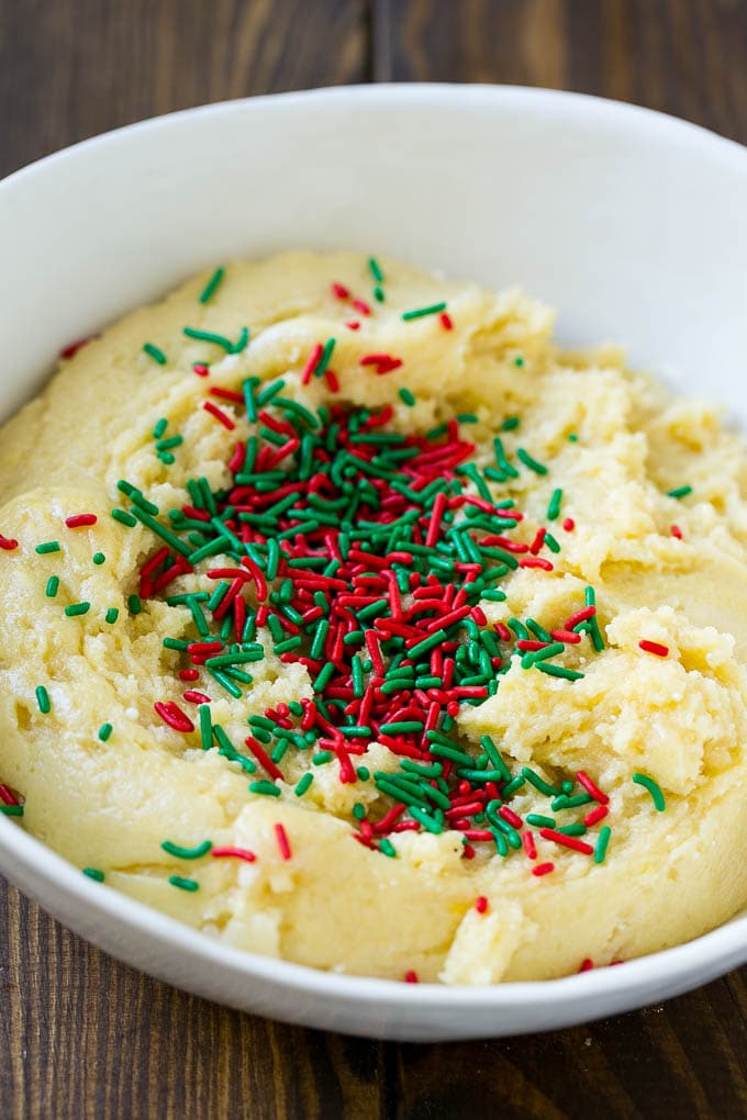 Cake Mix Cookies Recipe | Sprinkle Cookies | Christmas Cookies #cookies #christmas #sprinkles #dessert #baking #ezlod A bowl of dough with sprinkles on top.