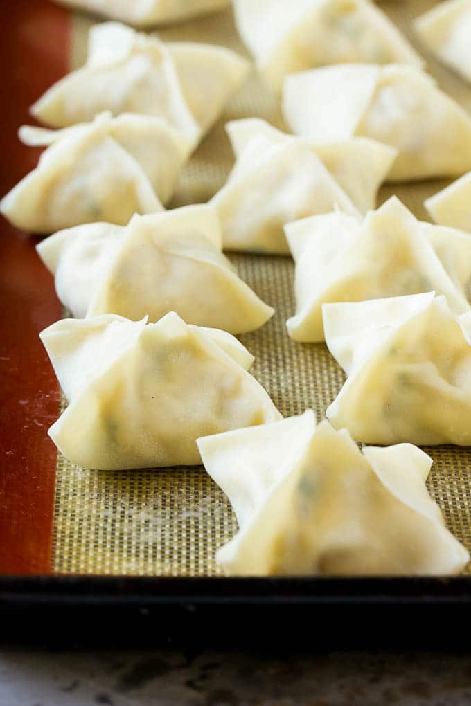 Crab Rangoon Recipe | Crab Wontons | Cream Cheese Wontons #crab #cheese #appetizer #snack #chinesefood #dinner #ezlod Raw wontons ready to go into the fryer.