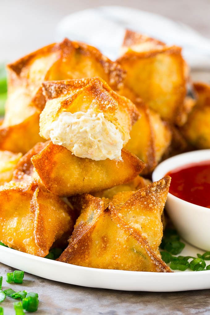 Crab Rangoon Recipe | Crab Wontons | Cream Cheese Wontons #crab #cheese #appetizer #snack #chinesefood #dinner #ezlod A cross section of crab rangoon with crispy wontons stuffed with cream cheese and crab.