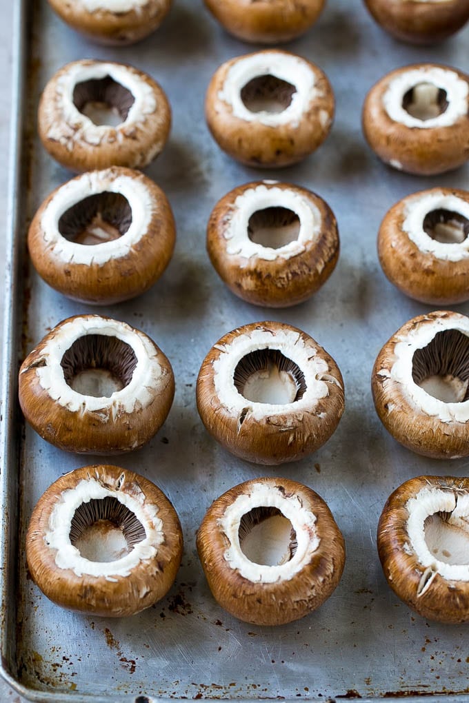 Crab Stuffed Mushrooms Recipe | Stuffed Mushrooms | Mushroom Appetizer #crab #seafood #mushrooms #lowcarb #appetizer #ezlod Cremini mushroom caps on a sheet pan.