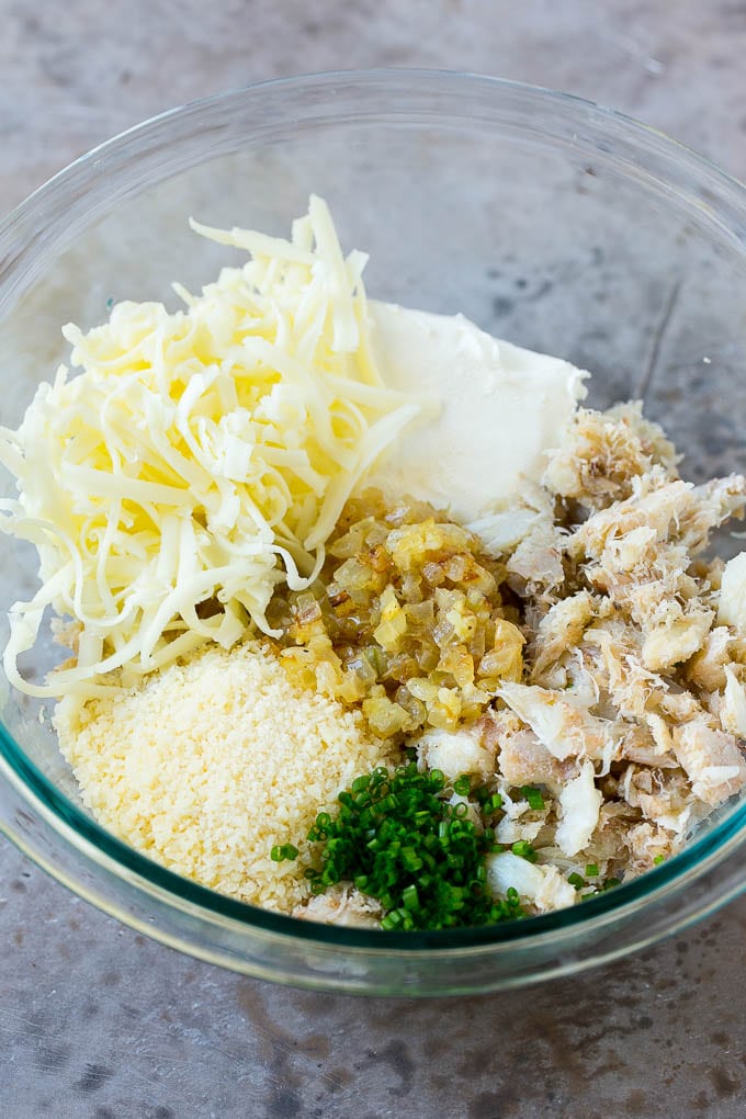 Crab Stuffed Mushrooms Recipe | Stuffed Mushrooms | Mushroom Appetizer #crab #seafood #mushrooms #lowcarb #appetizer #ezlod A bowl of crab meat, cheese, chives, onions and garlic.