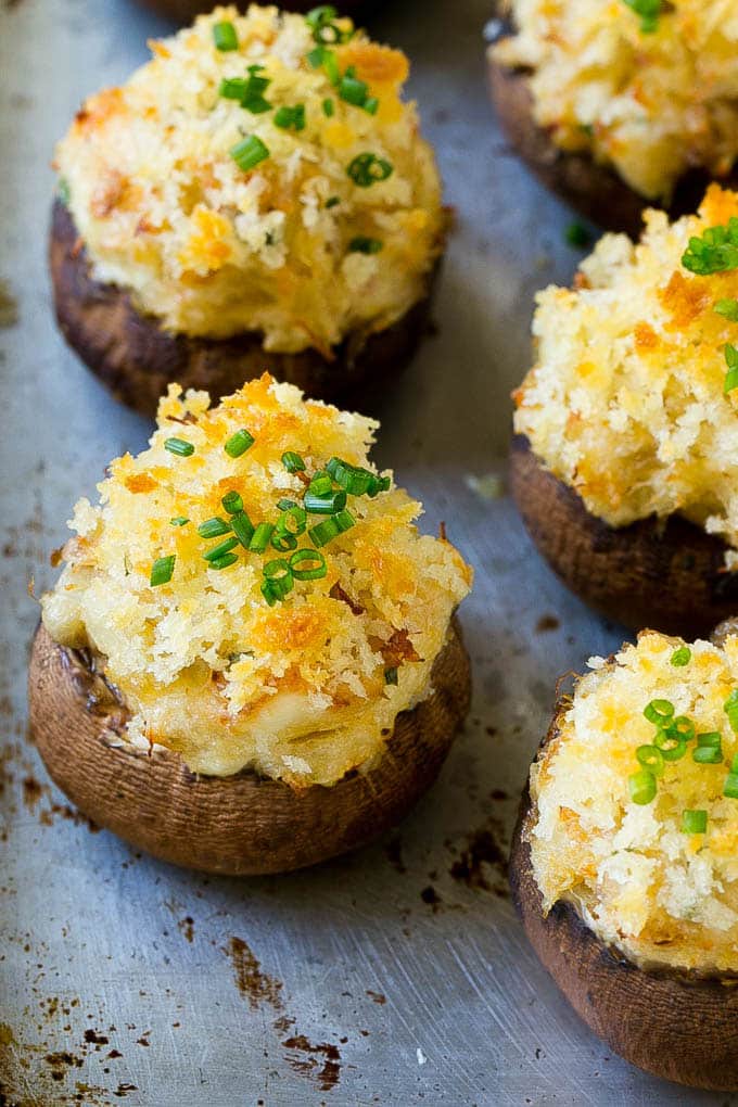 Crab Stuffed Mushrooms Recipe | Stuffed Mushrooms | Mushroom Appetizer #crab #seafood #mushrooms #lowcarb #appetizer #ezlod Crab stuffed mushrooms on a sheet pan topped with sliced chives.