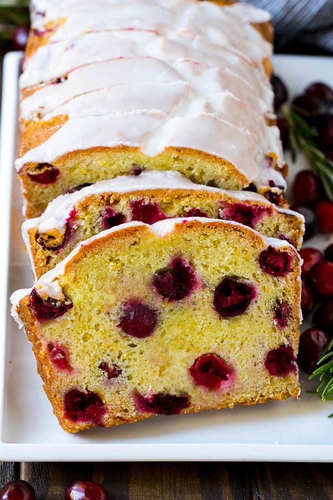 Cranberry Bread Recipe | Cranberry Loaf | Cranberry Orange Bread #cranberry #bread #baking #dessert #fall #ezlod Slices of cranberry bread topped with orange glaze.