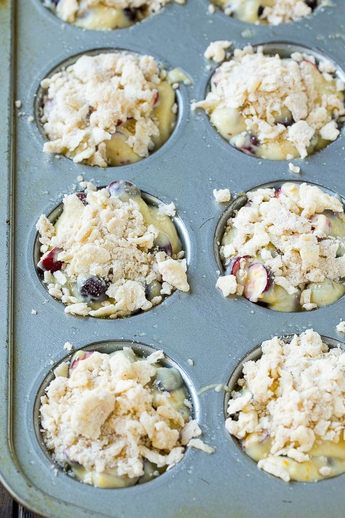 Cranberry Muffins Recipe | Cranberry Orange Muffins #cranberry #muffins #orange #fall #dessert #ezlod Muffins topped with streusel ready to go into the oven.