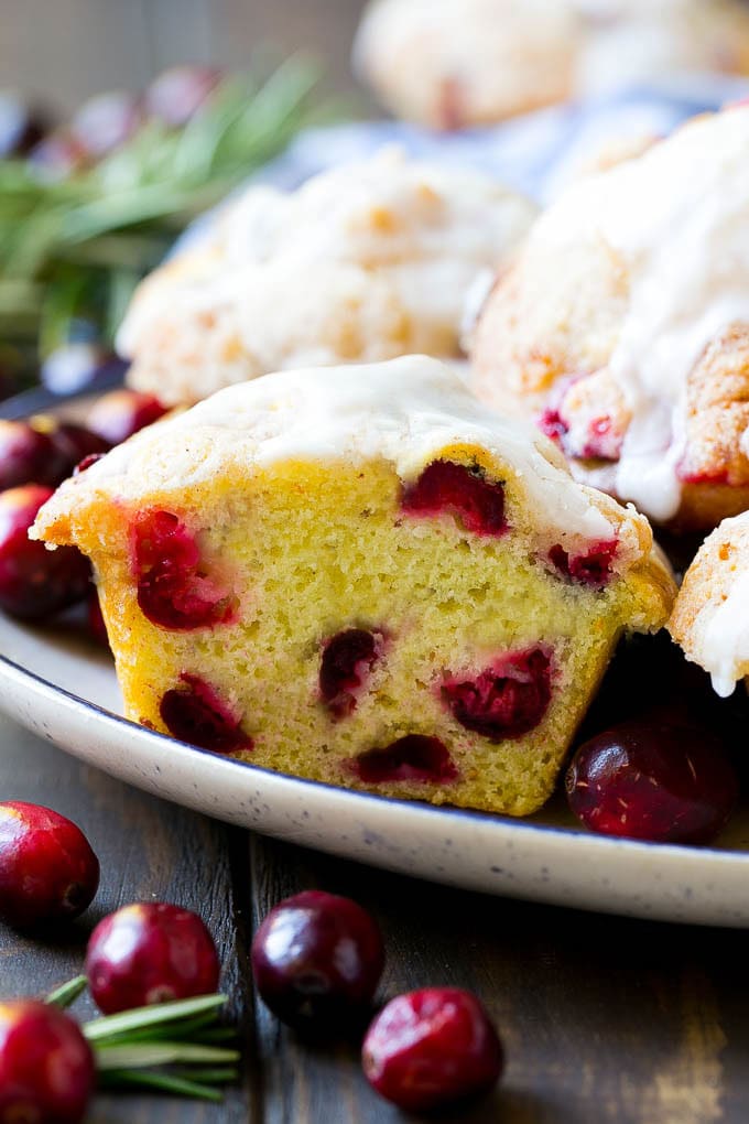 Cranberry Muffins Recipe | Cranberry Orange Muffins #cranberry #muffins #orange #fall #dessert #ezlod A plate of muffins with one cut in half.