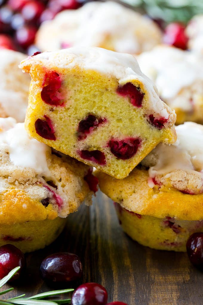 Cranberry Muffins Recipe | Cranberry Orange Muffins #cranberry #muffins #orange #fall #dessert #ezlod A stack of cranberry muffins with one muffin cut in half.
