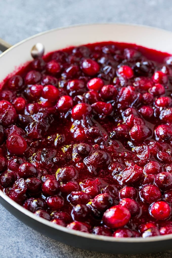 Cranberry Orange Sauce Recipe | Homemade Cranberry Sauce | Fresh Cranberry Sauce #cranberry #orange #fall #thanksgiving #sauce #dinner #ezlod Cranberry orange sauce simmering in a skillet.