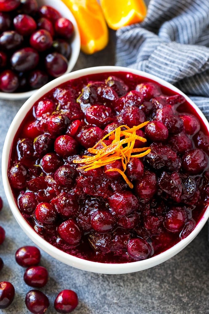 Cranberry Orange Sauce Recipe | Homemade Cranberry Sauce | Fresh Cranberry Sauce #cranberry #orange #fall #thanksgiving #sauce #dinner #ezlod Cranberry orange sauce, topped with fresh orange zest in a serving bowl.