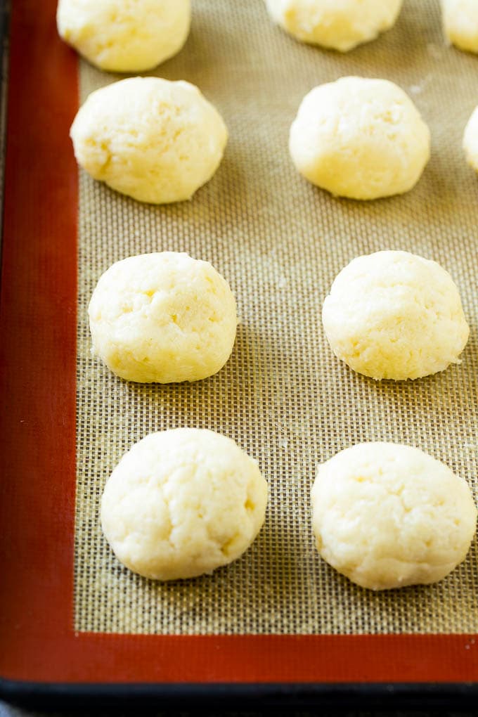 Gooey Butter Cookies Recipe | Cake Mix Cookies | Sprinkle Cookies | Christmas Cookies #cookies #butter #sprinkles #christmas #dessert #baking #ezlod Balls of dough on a baking sheet.