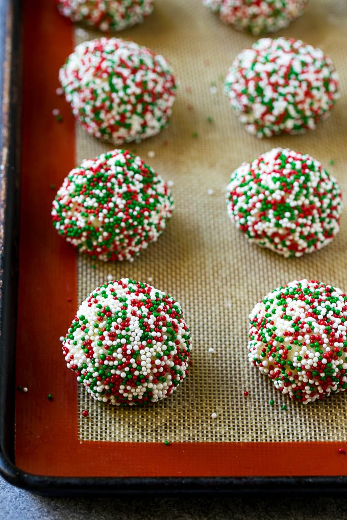 Gooey Butter Cookies Recipe | Cake Mix Cookies | Sprinkle Cookies | Christmas Cookies #cookies #butter #sprinkles #christmas #dessert #baking #ezlod Balls of dough rolled in sprinkles.