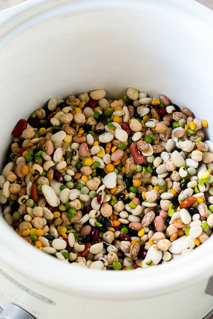Ham and Bean Soup Recipe | Slow Cooker Ham and Bean Soup | Crockpot Ham and Bean Soup | Leftover Ham Recipe #ham #beans #soup #slowcooker #crockpot #dinner #ezlod A mixture of dried beans in a crock pot.
