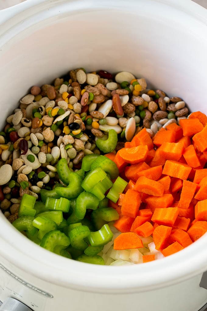 Ham and Bean Soup Recipe | Slow Cooker Ham and Bean Soup | Crockpot Ham and Bean Soup | Leftover Ham Recipe #ham #beans #soup #slowcooker #crockpot #dinner #ezlod Dried beans, carrots, onions and celery in the slow cooker.