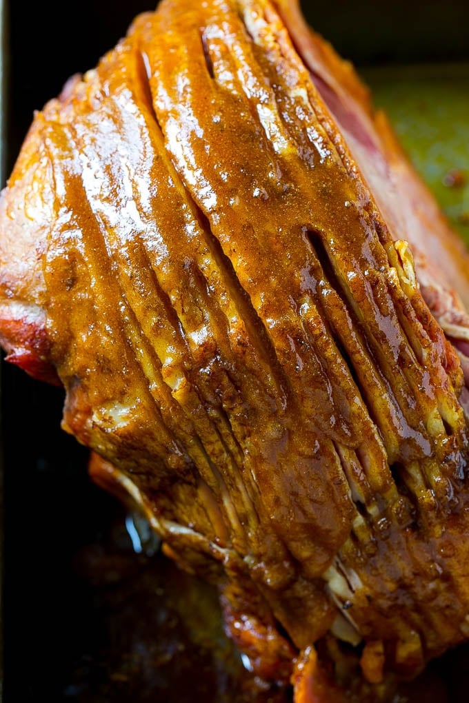 Honey Baked Ham Recipe | Glazed Ham | Holiday Ham #ham #dinner #ezlod #christmas #thanksgiving #easter A ham coated in sugar glaze in a baking pan.