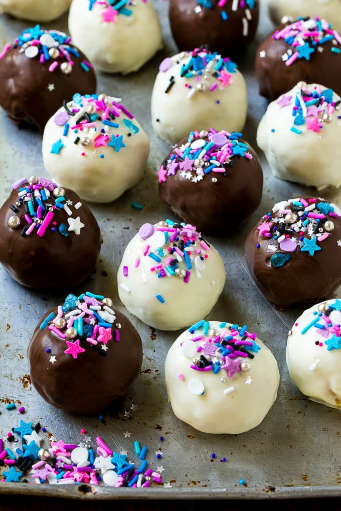 Oreo Balls Recipe | Oreo Truffles | Homemade Candy #truffles #candy #oreos #chocolate #sprinkles #dessert #christmas #ezlod Assorted colors of Oreo balls on a sheet pan.