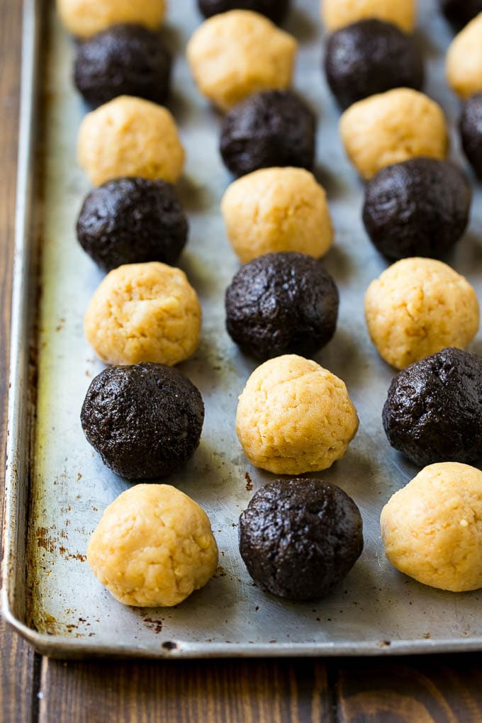 Oreo Balls Recipe | Oreo Truffles | Homemade Candy #truffles #candy #oreos #chocolate #sprinkles #dessert #christmas #ezlod Oreo ball centers made from vanilla and chocolate Oreos on a sheet pan.