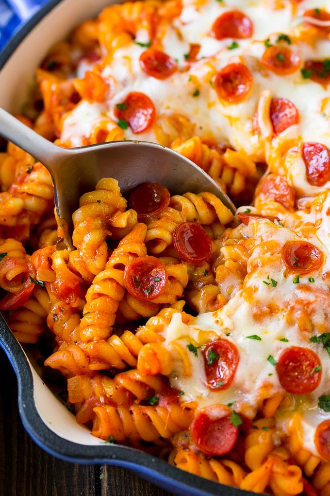 Pizza Pasta Recipe | Pepperoni Pasta | Sausage Pasta #italian #pepperoni #sausage #pizza #pasta #dinner #ezlod #onepot A pan of pizza pasta with a serving spoon in it.