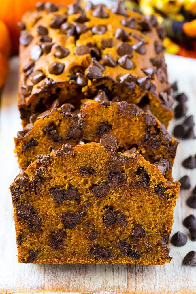 Pumpkin Chocolate Chip Bread Recipe | Pumpkin Bread | Chocolate Pumpkin Bread #pumpkin #bread #fall #chocolate #baking #dessert #ezlod Sliced pumpkin chocolate chip bread on a serving board.
