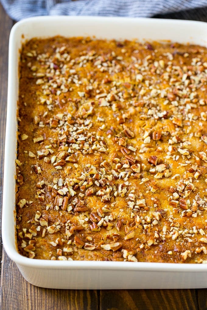 Pumpkin Dump Cake Recipe | Pumpkin Cake | Pumpkin Pie Cake #pumpkin #cake #pecans #fall #thanksgiving #dessert #ezlod A pan of pumpkin dump cake topped with chopped pecans.