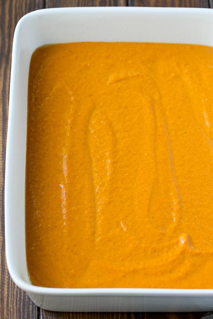 Pumpkin Dump Cake Recipe | Pumpkin Cake | Pumpkin Pie Cake #pumpkin #cake #pecans #fall #thanksgiving #dessert #ezlod Pumpkin pie filling poured into a baking dish.