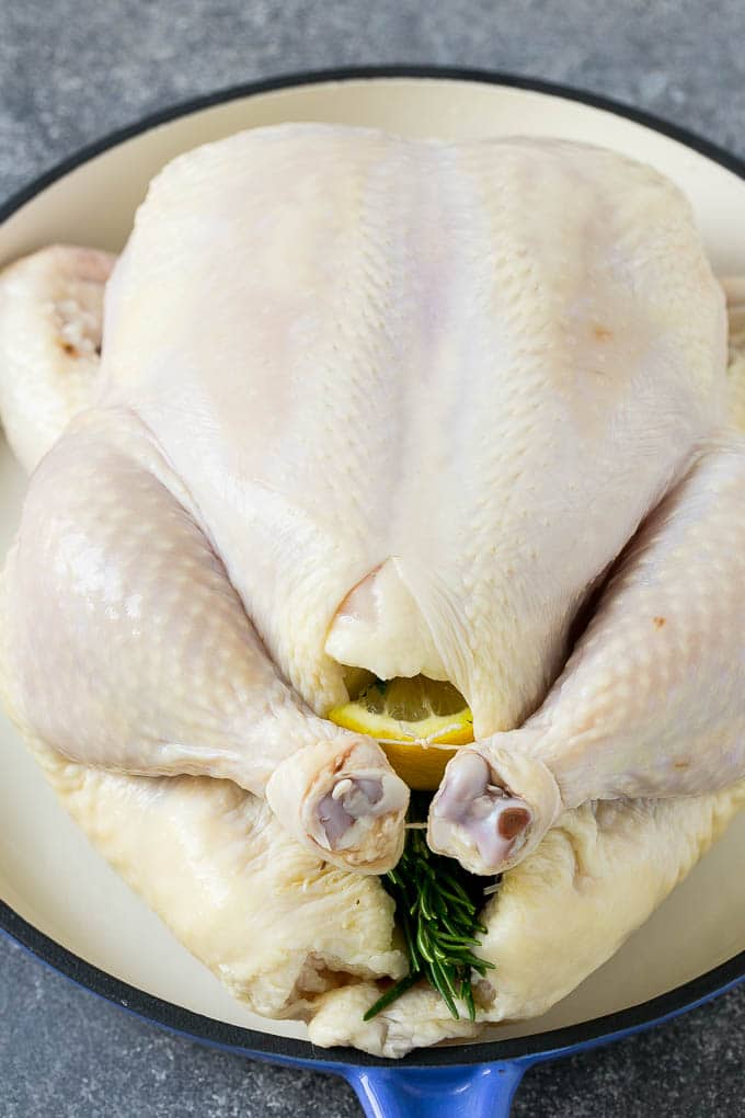 Roasted Chicken Recipe | Whole Roasted Chicken | Roast Chicken #chicken #dinner #lowcarb #keto #ezlod A raw chicken stuffed with lemon, onion and herbs.