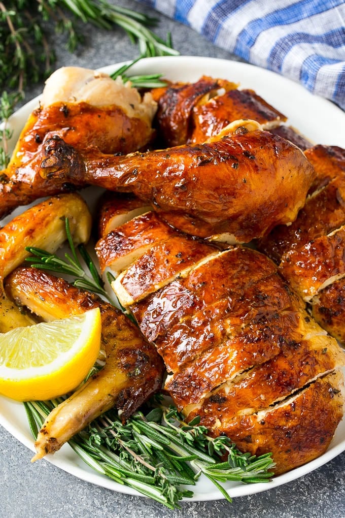 Roasted Chicken Recipe | Whole Roasted Chicken | Roast Chicken #chicken #dinner #lowcarb #keto #ezlod Carved roasted chicken on a serving platter with fresh herbs.