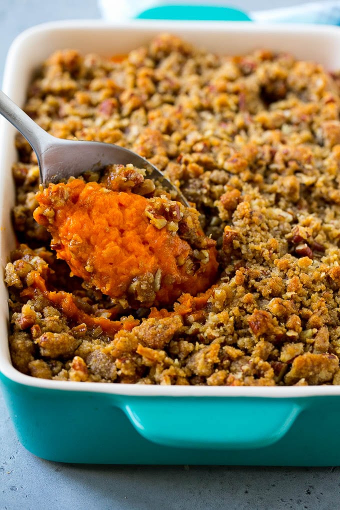 Ruth's Chris Sweet Potato Casserole Recipe | Sweet Potato Casserole | Mashed Sweet Potatoes #sweetpotatoes #casserole #thanksgiving #christmas #holidays #dinner #ezlod #sidedish Ruth's Chris sweet potato casserole with a serving spoon in it.