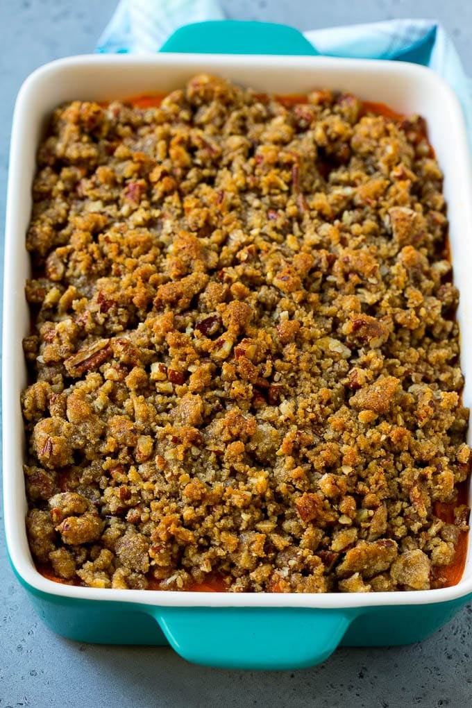 Ruth's Chris Sweet Potato Casserole Recipe | Sweet Potato Casserole | Mashed Sweet Potatoes #sweetpotatoes #casserole #thanksgiving #christmas #holidays #dinner #ezlod #sidedish A baking dish of Ruth's Chris sweet potato casserole topped with streusel.