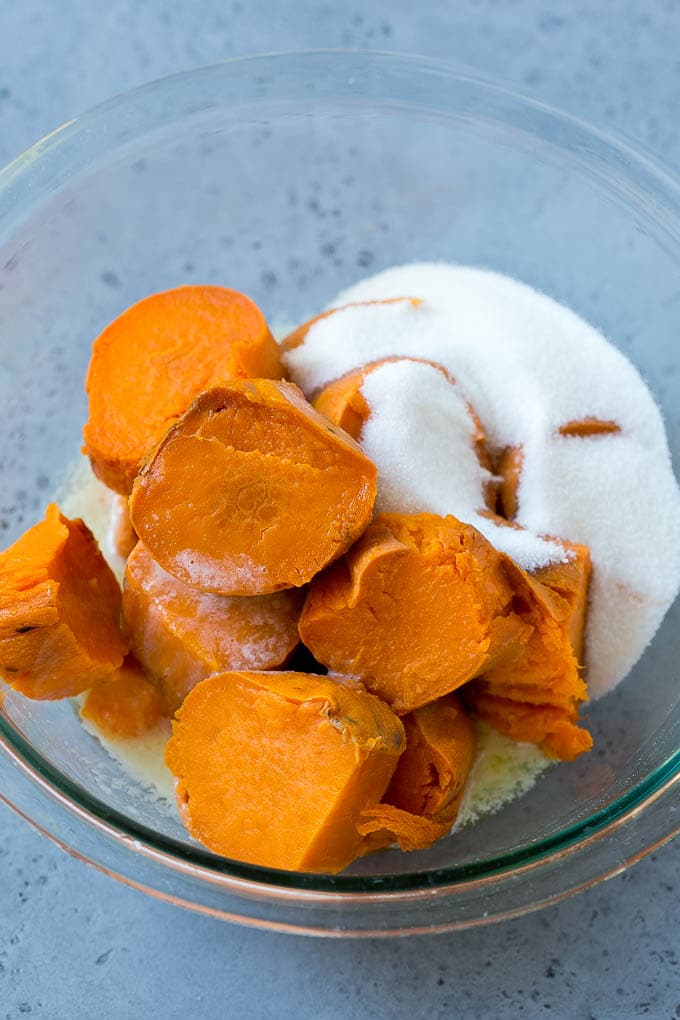Ruth's Chris Sweet Potato Casserole Recipe | Sweet Potato Casserole | Mashed Sweet Potatoes #sweetpotatoes #casserole #thanksgiving #christmas #holidays #dinner #ezlod #sidedish Sweet potatoes, sugar and butter in a bowl.
