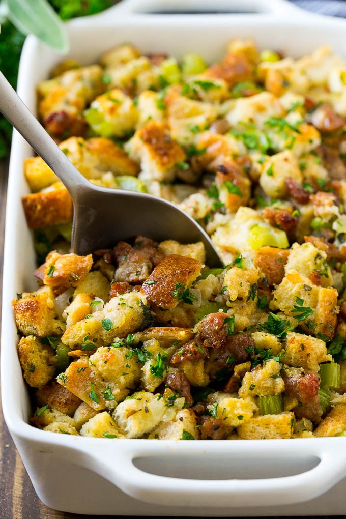 Sausage Stuffing Recipe | Thanksgiving Stuffing | Make Ahead Stuffing #stuffing #thanksgiving #sausage #sidedish #dinner #ezlod A baking dish of sausage stuffing with a serving spoon in it.