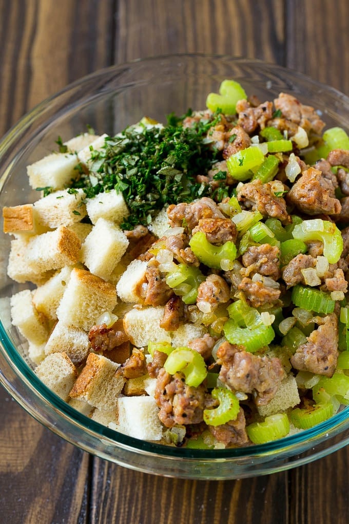 Sausage Stuffing Recipe | Thanksgiving Stuffing | Make Ahead Stuffing #stuffing #thanksgiving #sausage #sidedish #dinner #ezlod Meat, sauteed vegetables and bread cubes in a mixing bowl.