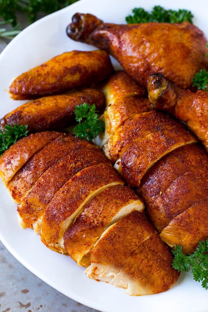 Smoked Chicken Recipe | Whole Smoked Chicken | BBQ Chicken #chicken #smoker #BBQ #dinner #ezlod #glutenfree #lowcarb Carved smoked chicken including drumsticks, wings and chicken breasts on a serving platter.