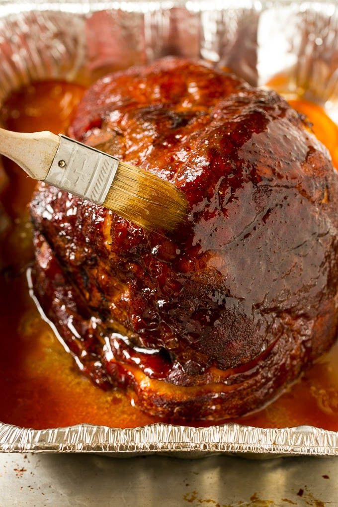 Brown Sugar Smoked Ham Recipe | Holiday Ham Recipe | Brown Sugar Glazed Ham #ham #christmas #thanksgiving #easter #smoker #dinner #brownsugar #ezlod #glutenfree Brown sugar glaze brushed on the pork.