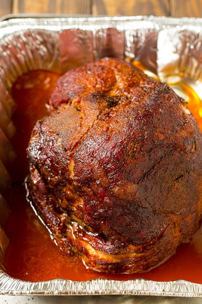 Brown Sugar Smoked Ham Recipe | Holiday Ham Recipe | Brown Sugar Glazed Ham #ham #christmas #thanksgiving #easter #smoker #dinner #brownsugar #ezlod #glutenfree BBQ rub coating the meat.